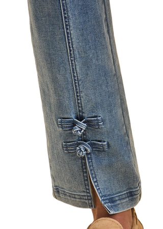 Close-up of blue jeans with a beige background