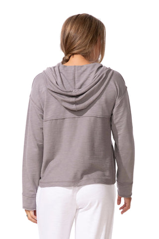 Person wearing a gray hoodie with a white background