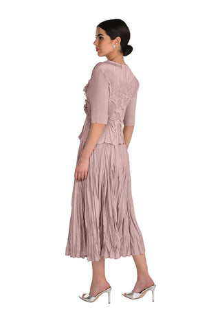 Woman wearing a pink dress with a plain background