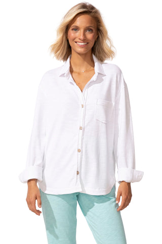 Woman wearing a white shirt and light green pants on a white background
