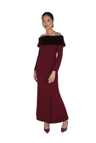 A woman modeling a long off-the-shoulder maxi dress in deep burgundy with a contrasting dark brown velvet collar, set against a plain white studio background.