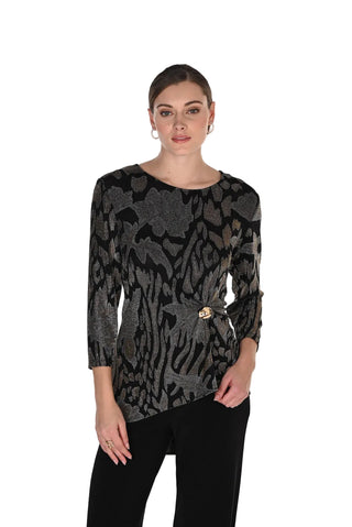 A woman modeling a black and gray patterned long-sleeve top with a small gold button detail at the waist, paired with black pants, against a plain white background.