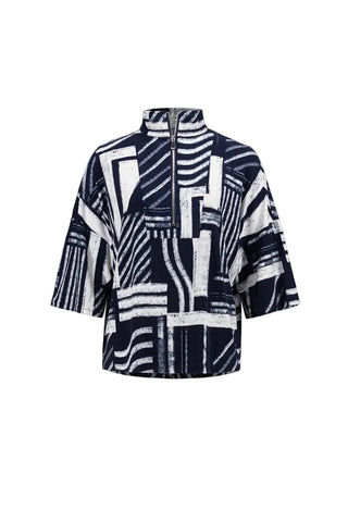 A short-sleeved half-zip jacket featuring a bold geometric abstract pattern in navy blue and white, displayed against a light gray background.