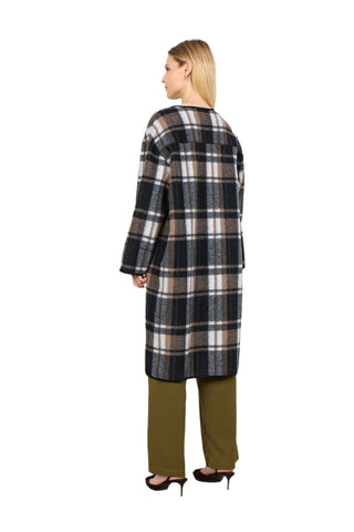 Woman wearing a plaid coat and green pants against a white background