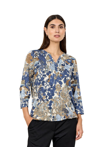 Woman wearing a floral blouse with long sleeves on a white background