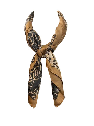 Leopard print scarf on a mannequin bust against a dark background