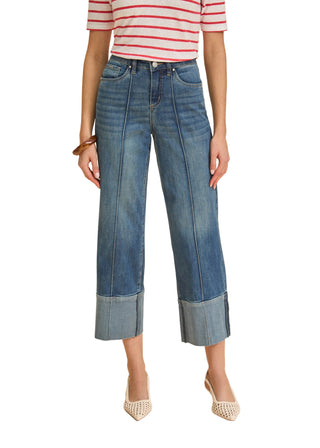 Person wearing blue jeans and a red and white striped shirt on a beige background