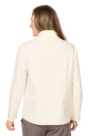Woman wearing a cream-colored blazer against a white background