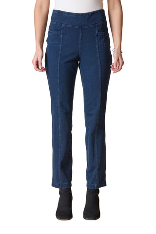 Person wearing blue jeans on a beige background
