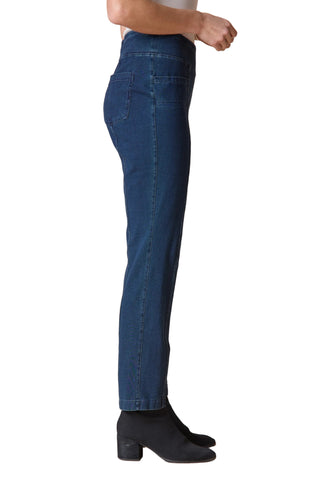 Person wearing blue jeans on a beige background