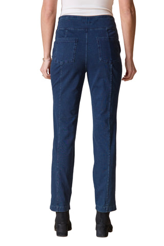 Person wearing blue jeans on a beige background