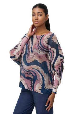 Woman wearing a patterned sweater and pants on a white background