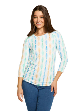 Woman wearing a colorful striped shirt and blue jeans on a white background