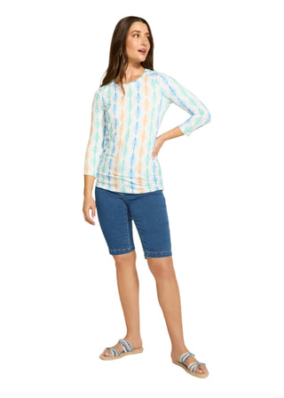 Woman wearing a striped shirt and blue shorts on a white background