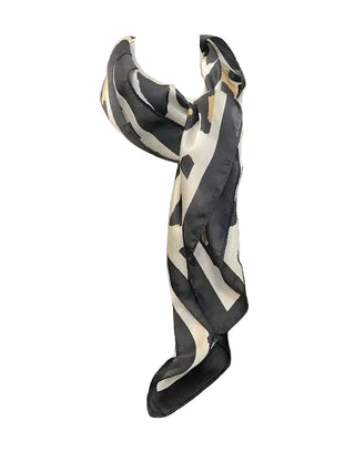 Black and white patterned scarf on a mannequin bust against a dark background