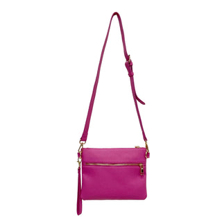 Pink crossbody bag with a strap on a white background