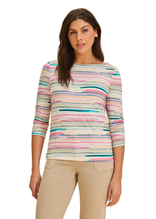 Woman wearing a multicolored striped sweater on a beige background