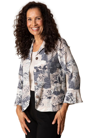 Woman wearing a patterned jacket against a plain background