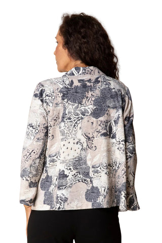 Person wearing a floral patterned blouse against a plain background