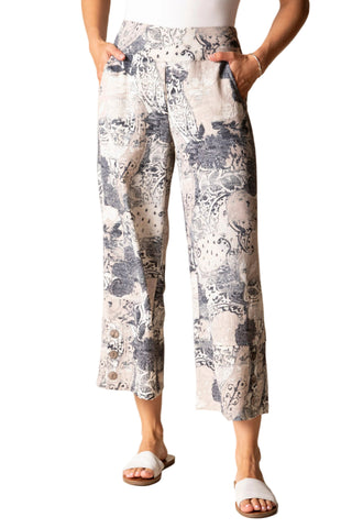 Person wearing floral-patterned pants on a beige background