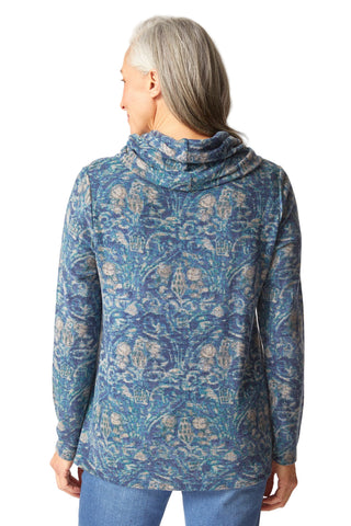 Woman wearing a blue patterned jacket on a white background