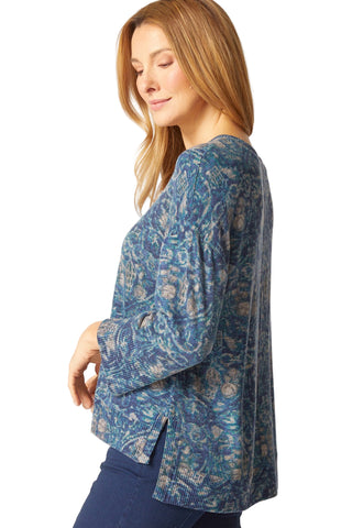 Woman wearing a blue patterned blouse on a white background