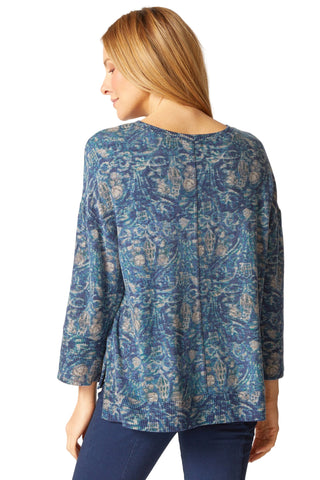 Woman wearing a blue patterned top on a white background