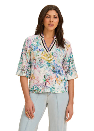 Woman wearing a floral blouse with a beige background