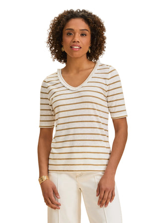 Woman wearing a striped shirt against a beige background