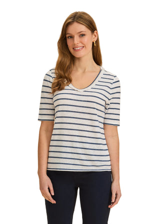 Woman wearing a striped shirt against a beige background