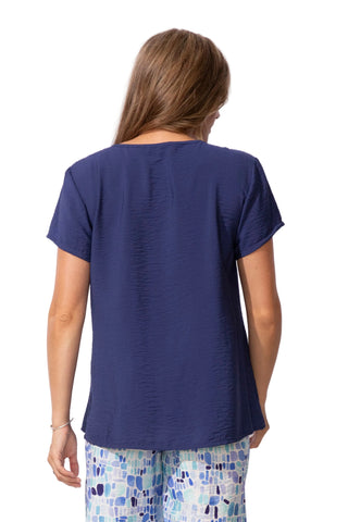 Person wearing a blue top with a plain white background