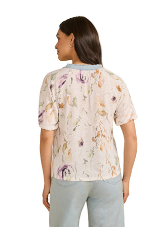 Woman wearing a floral blouse with a beige background
