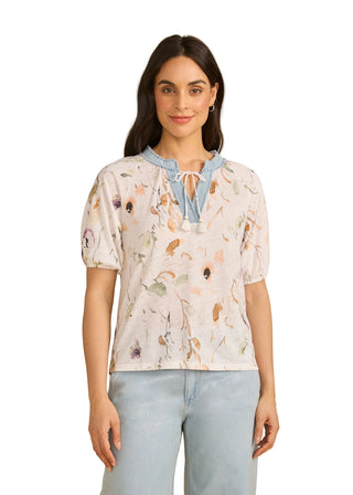 Woman wearing a floral blouse with a beige background