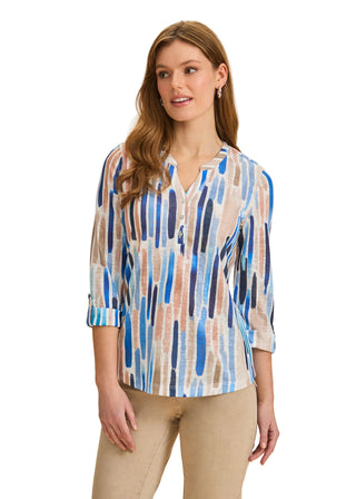 Woman wearing a patterned blouse with a beige background