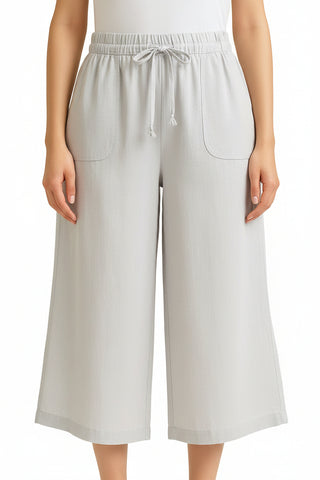 White wide-leg pants worn by a person on a white background
