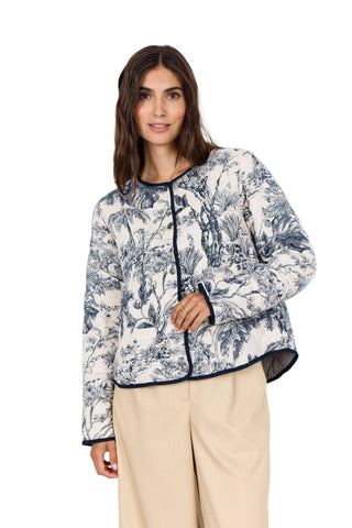 Woman wearing a floral patterned jacket on a white background