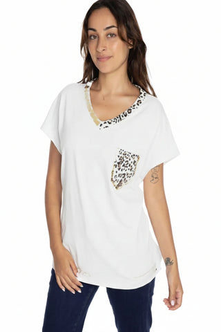 Woman wearing a white blouse with leopard print details