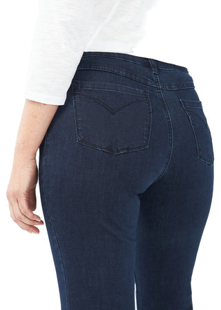 Navy blue jeans worn by a person on a white background