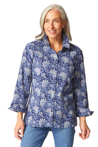 Woman wearing a blue floral shirt against a white background