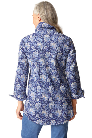 Person wearing a blue floral patterned shirt on a white background
