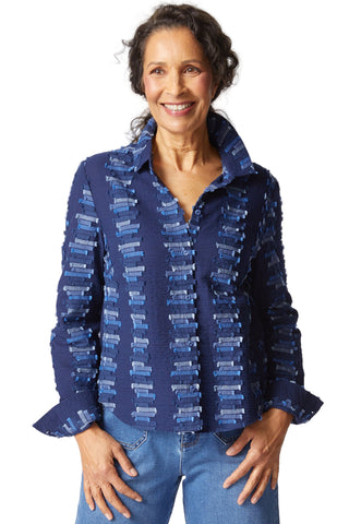 Woman wearing a blue patterned shirt against a white background