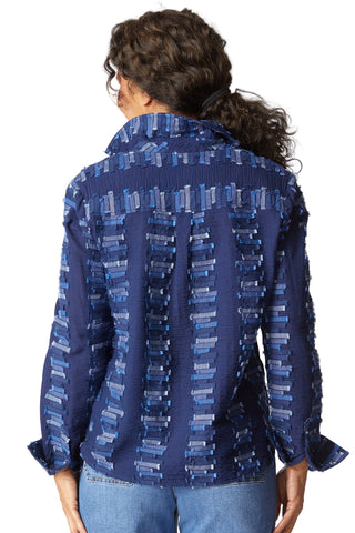 Person wearing a blue patterned shirt on a white background