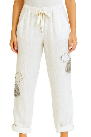 White pants with embellishments on a white background