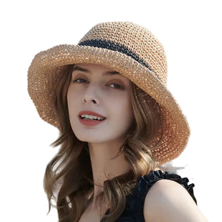 Woman wearing a straw hat with a blurred background