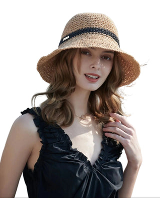 Woman wearing a straw hat with a blurred natural background