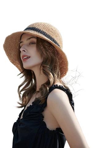 Woman wearing a straw hat with a blurred natural background