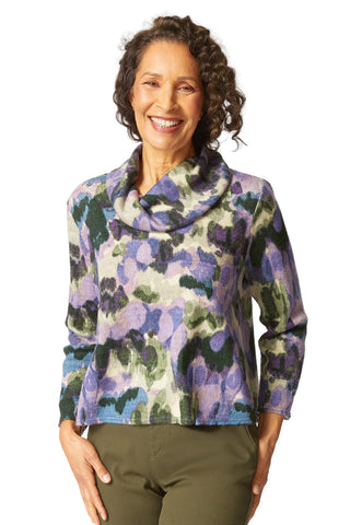 Woman wearing a floral patterned jacket on a white background