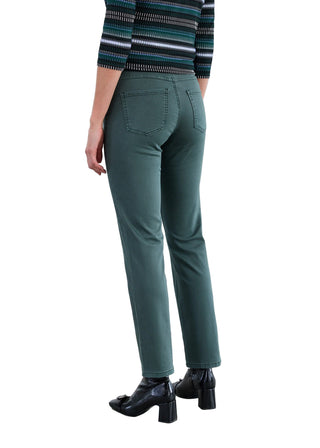 Person wearing green pants and a striped sweater on a plain background