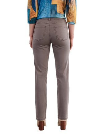 Person wearing brown pants and a colorful top against a white background