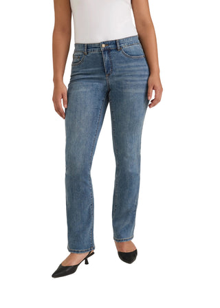 A model wearing a pair of medium-wash blue denim jeans with a straight-leg fit, paired with a white top and black pointed-toe heels, shown from the waist down against a light gray studio background.